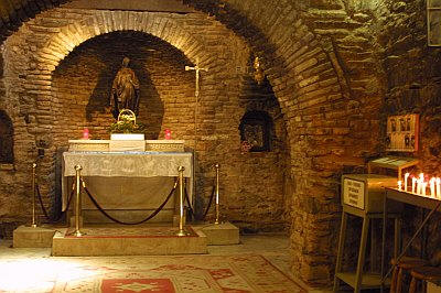 House of Virgin Mary: Located on the top of the “Bulbul” mountain 9 km ahead of Ephesus, the shrine of Virgin Mary enjoys a marvelous atmosphere hidden in the green. It is the place where Mary may have spent her last days. Indeed, she may have come in the area together with Saint John, who spent several years in the area to spread Christianity. Mary preferred this remote place rather than living in crowded place.The house of Virgin Mary is a typical Roman architectural example, entirely made of stones. In the 4th century AD, a church, combining her house and grave, has been built. The original two-stored house, which consisted of an anteroom (where today candles are proposed), bedroom and praying room (Christian church area) and a room with fireplace (chapel for Muslims). A front kitchen fell into ruins and has been restored in 1940’s. Today, only the central part and a room on the right of the altar are open to visitors. From there one can understand that this building looks more like a church than a house. Another interesting place is the “Water of Mary”, a source to be found at the exit of the church area and where a rather salt water, with curative properties, can be drunk by all. Paul VI was the first pope to visit this place in the 1960’s. Later, in the 1980’s, during his visit, Pope John-Paul II declared the Shrine of Virgin Mary has a pilgrimage place for Christians. It is also visited by Muslims who recognize Mary as the mother of one of their prophets. Every year, on August 15th a ceremony is organized to commemorate Mary’s Assumption 